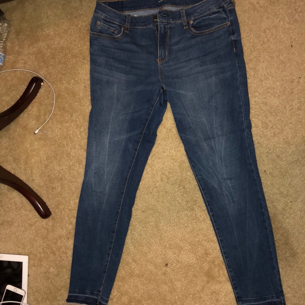 Dark wash skinny jeans with frayed bottoms